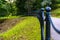 Colorful Photo of the Road in a Park, Between Woods - Closeup view of the Chain Fence with Blurred Background with Space for Text