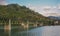 Colorful picture of a metal trestle bridge in Bosnia over a wide river. Five spans of bridge are visible