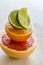 Colorful pile of half citrus fruit, top view, macro.