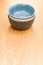 colorful piled up empty stoneware bowls on a wooden tabletop with copy space