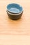 colorful piled up empty stoneware bowls on a wooden tabletop with copy space