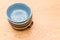 colorful piled up empty stoneware bowls on a wooden tabletop with copy space