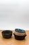 colorful piled up empty stoneware bowls on a wooden tabletop with copy space