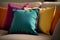 Colorful pillows on sofa, closeup. Interior design concept