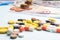 Colorful pills and capsules on background of dollar and euro banknotes. concept of high cost treatment, preservation of health and