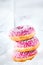 Colorful pink glazed ring doughnuts