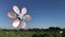 Colorful pinwheel toy against blue sky landscape