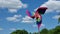 Colorful pinwheel toy against the blue sky with white clouds.