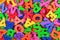 Colorful plastic alphabet letters as background