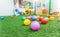 Colorful plastic ball on green turf at school playground