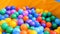 Colorful plastic balls in a pool for for children. Stock footage. Close up of lots of colored balls in a playground ball
