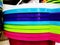 Colorful plastic bowls displayed on shelves for sale in a supermarket