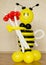 Colorful plastic bumble bee with red flowers