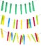 Colorful plastic clothespins hanging on ropes against white background