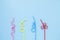 Colorful plastic coctail straw on blue background. Red, pink, yellow, blue in many shapes straw