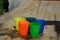 Colorful plastic cups on a wooden table