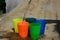 Colorful plastic cups on a wooden table