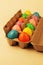 Colorful plastic Easter eggs in an egg carton