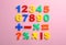 Colorful plastic magnetic numbers on color background