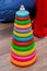 Colorful plastic rainbow toy pyramid for little kids on the blue background. Children\'s bright multi-colored toys. Colorful Woode