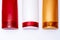 Colorful plastic shampoo and hair conditioner bottles close up on white background