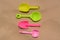 Colorful plastic shovels on sand, flat lay. Beach toys