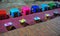 Colorful plastic stools and traditional sticky rice baskets lined up on the street pre-dawn in Luang Prabang, Laos