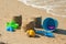 Colorful plastic toys on the sandy beach