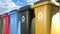 Colorful plastic trash cans with a logo recycling