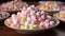 A colorful plate of marshmallows in different shapes and sizes