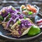 Colorful plate of three mexican carnitas street tacos