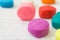 Colorful playdough on wooden table.