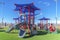 Colorful playground for children on a grassy terrain viewed on a sunny day