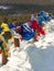 Colorful prayer flags with tibetan mantras hanging out in wind at snowy temple complex, asian culture at local monastery