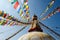 Colorful praying flags and buddhist stupa in sunlight in nepal