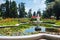 Colorful private garden with fountain and pond.