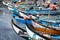 Colorful prows of the Portuguese fishing fleet moliceiros at the end of day tied up at a community dock