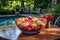 colorful punch bowl with floating fruit on garden table