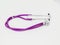 Colorful purple stethoscope on white background. Close-up. Medicine