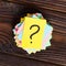 Colorful question marks written reminders tickets on wooden background