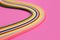 Colorful quilling, twisting paper, abstract rainbow on pink background