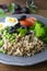 Colorful quinoa buddha plate withbroccoli, egg, spring onion, tomatoes and green peas. Home made food. Concept for a tasty and