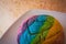 Colorful Rainbow Concha Mexican Pastry on a white plate.