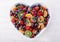 Colorful rainbow fruit in heart shape bowl.