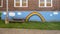 Colorful rainbow painting outside Mount Auburn School in Dallas, Texas.