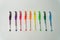 colorful rainbow pens on white background in a row