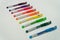 colorful rainbow pens on white background in a row