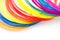 Colorful rainbow plastic filaments with for 3D pen laying on white background. New toy for child.