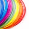 Colorful rainbow plastic filaments for 3D pen laying on white background. New toy for child.