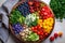 colorful rainbow salad and wholesome fruits with berries in wooden plate